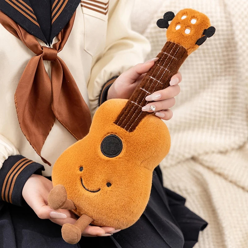Person holding a kawaii plush toy guitar with a smiley face design.