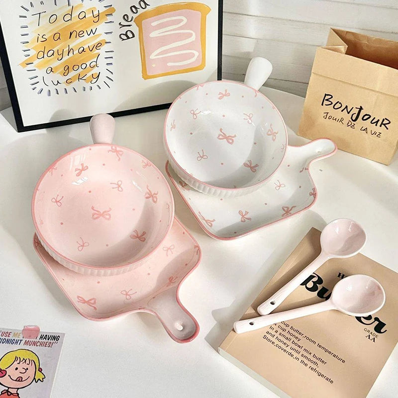 Two sets of pink and white kawaii ramen bowls with spoons
