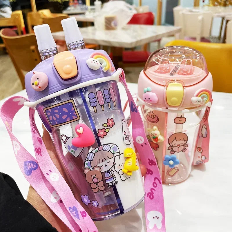 Two cartoon-themed kawaii water bottles with colorful designs on a table.