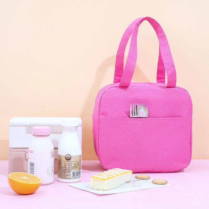 Pink kawaii lunch bag with food items on a pink background
