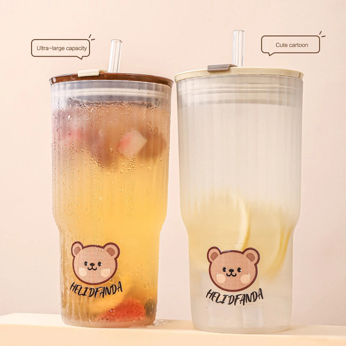 Two kawaii tumblers with cartoon teddy bear design and 'HELIDFANDA' branding on a beige background.