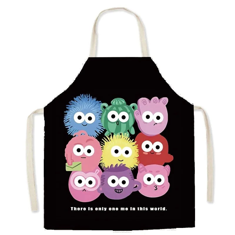 Black kawaii apron with colorful cartoon characters and text on a white background
