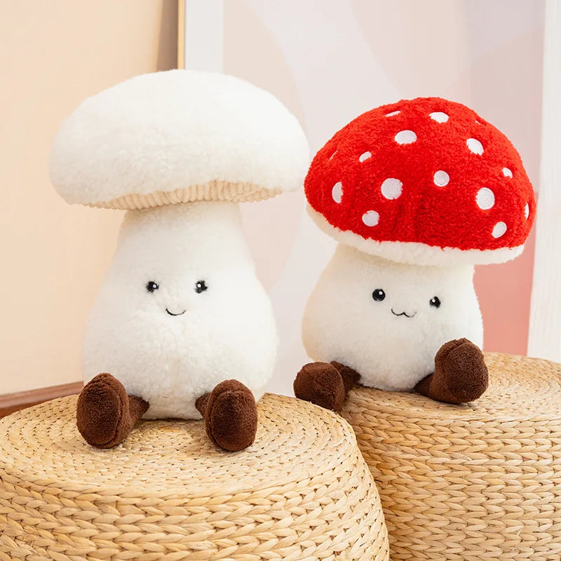 Two kawaii plush mushroom toys, one white with a red cap and one white with a red polka dot cap, sitting on woven stools.