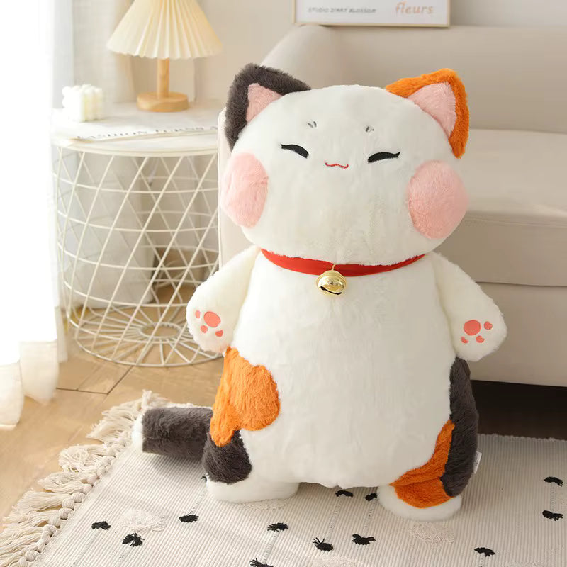 Plush cat toy with a bell on a rug in a room setting