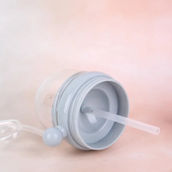 Kawaii water bottle lid with straw on a soft pink background