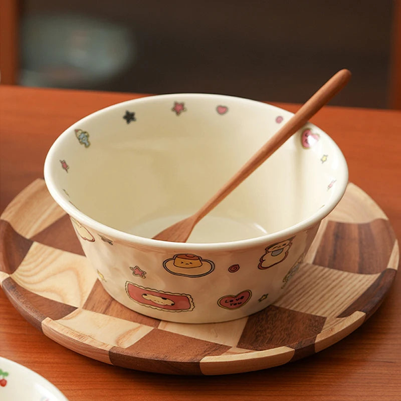 Ceramic kawaii ramen bowl with cartoon designs on a wooden tray