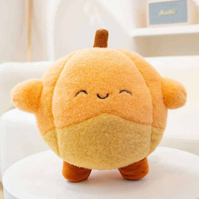 Kawaii plush toy resembling a cartoonish pumpkin with a smiling face on a white surface.