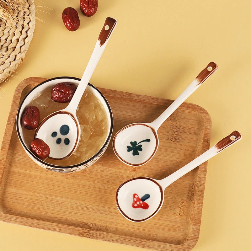 Three white ceramic kawaii spoons on a table