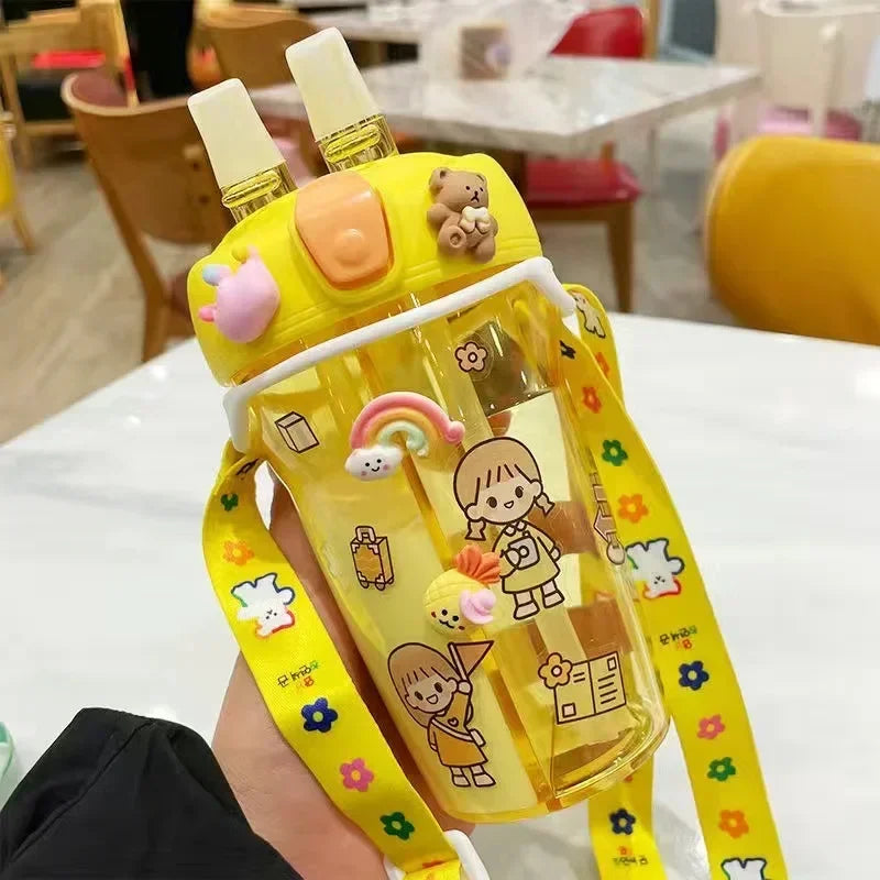 Yellow cartoon-style kawaii water bottle with a strap in an indoor setting