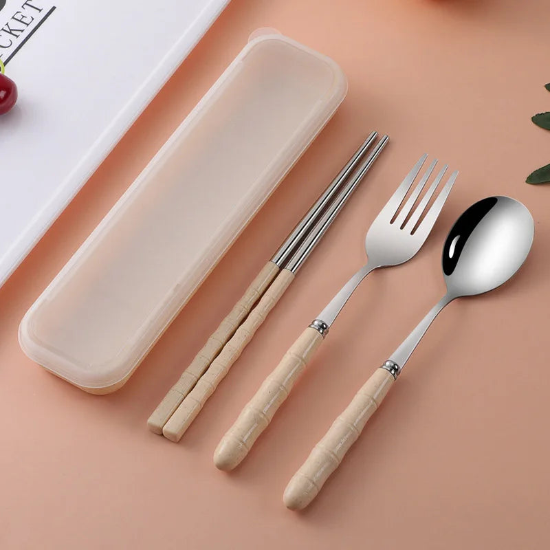 Set of kawaii utensils with beige handles including a fork, spoon, and chopsticks on a peach background.