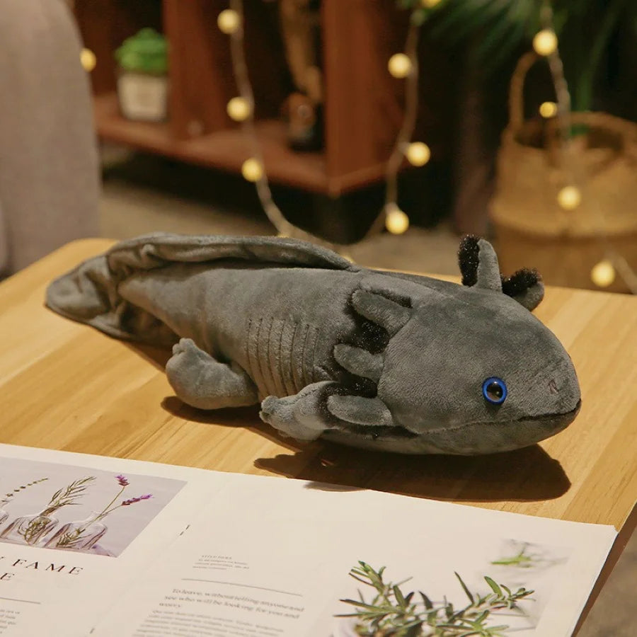 Plush axolotl kawaii toy on a wooden surface with a blurred background
