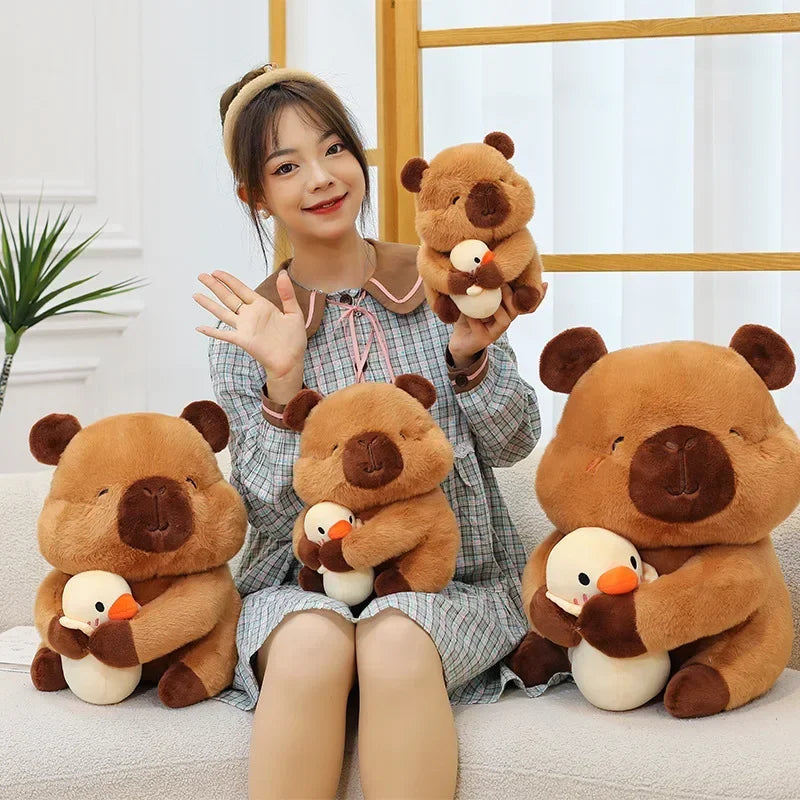 Person holding and posing with teddy bear and duck kawaii plush toys in a home setting.