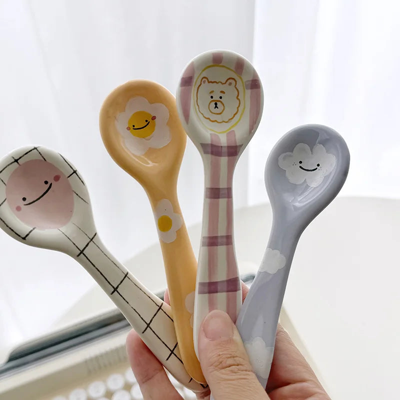 A person holding four kawaii spoons