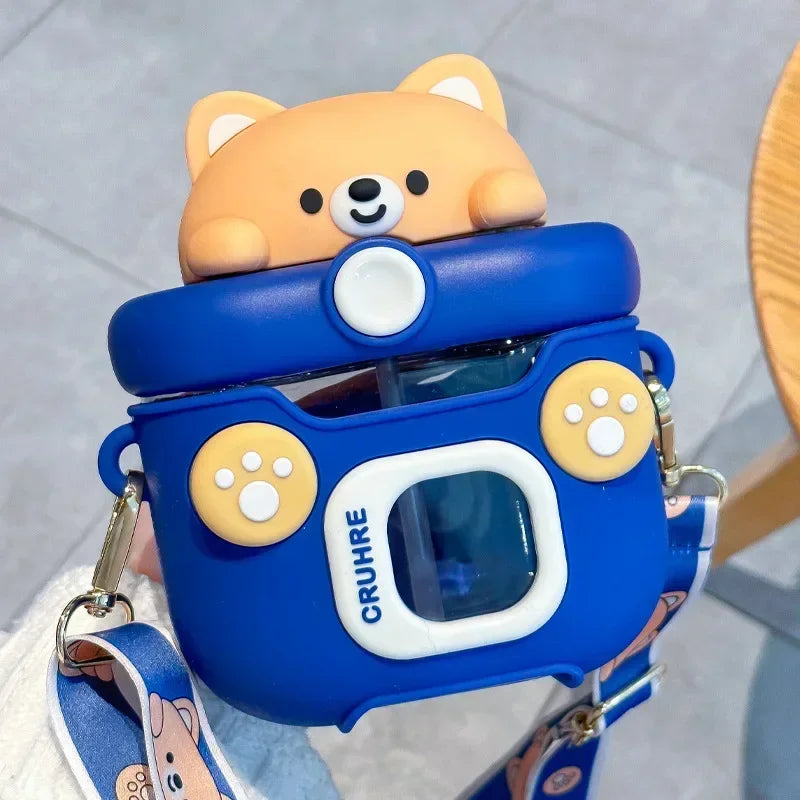 Blue camera-shaped kawaii water bottle with a bear design on top, featuring the brand 'CRUHE'.