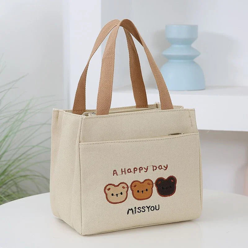 Beige kawaii tote bag with embroidered designs and text on a light background