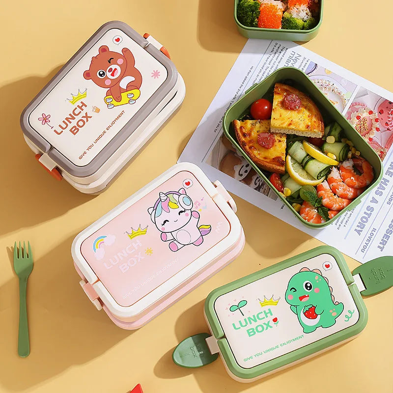 Three colorful kawaii lunch boxes with animal designs on a yellow surface with food and a fork.