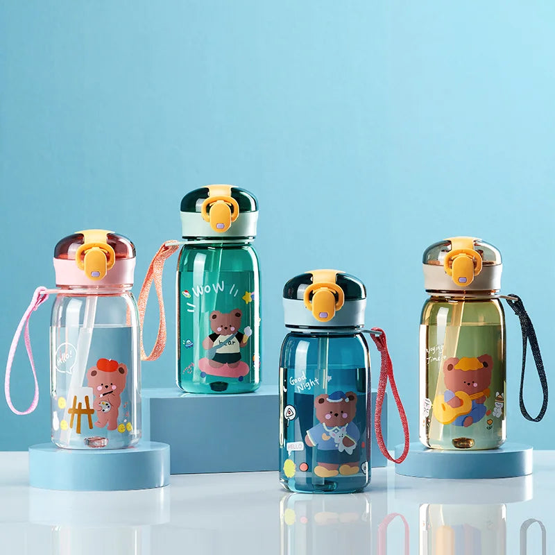 Set of four colorful kawaii water bottles with cartoon bear designs on a blue background