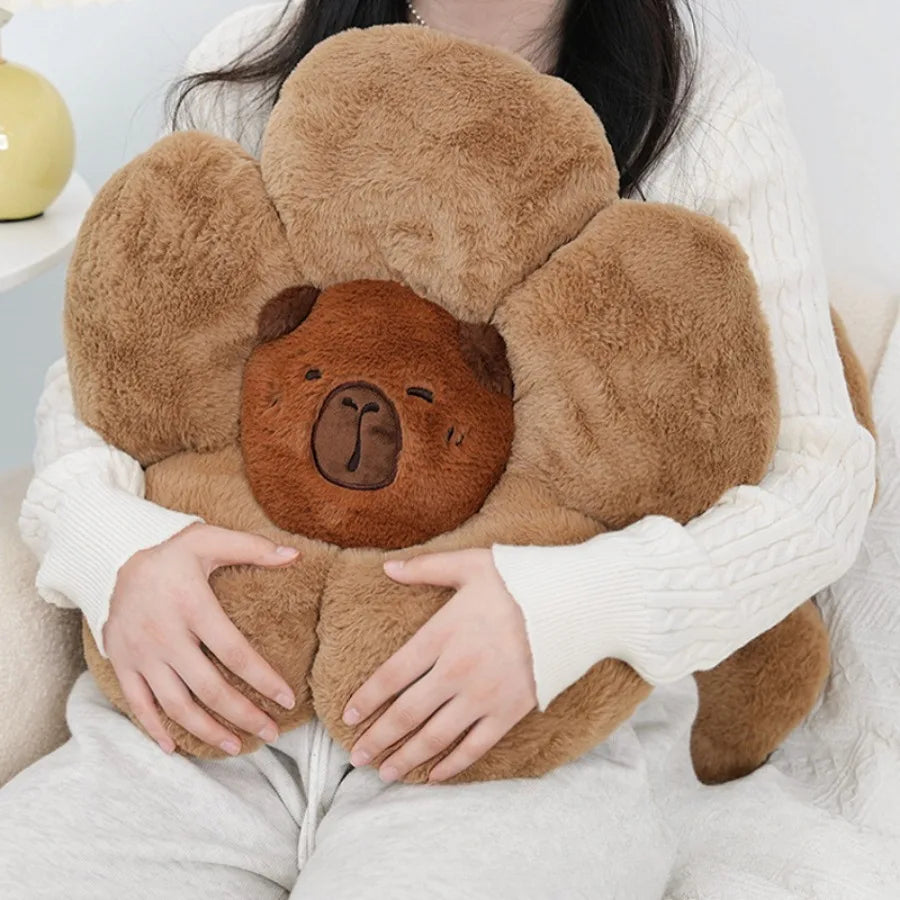 Person holding a brown teddy bear-shaped kawaii pillow