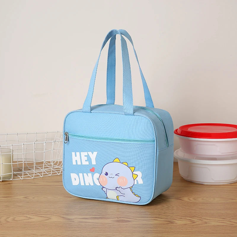 Light blue kawaii bag with cartoon dinosaur design and text on a wooden surface.