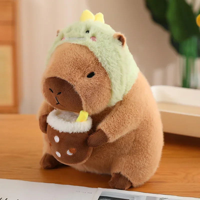 Kawaii plush toy resembling a bear with a green hood on a wooden surface