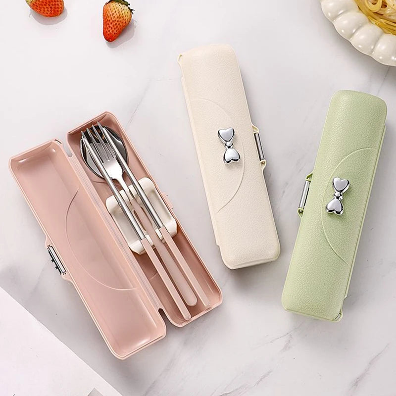 A set of three kawaii utensils in different colors on a table
