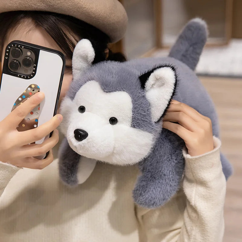 Person holding a kawaii plush husky toy and taking a selfie.