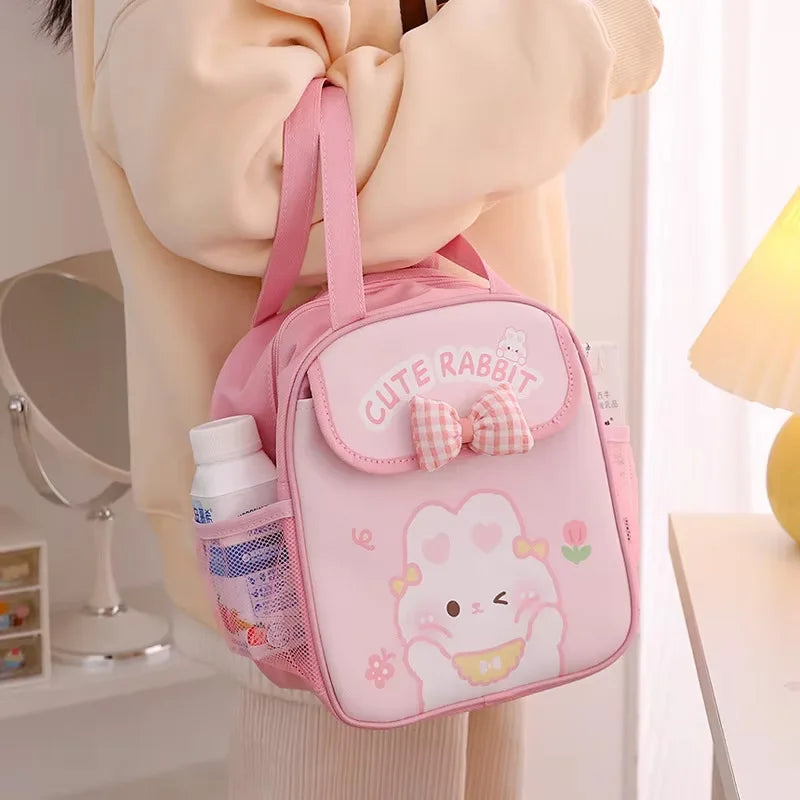 Pink 'Cute Rabbit' kawaii backpack held by a person in a room setting.
