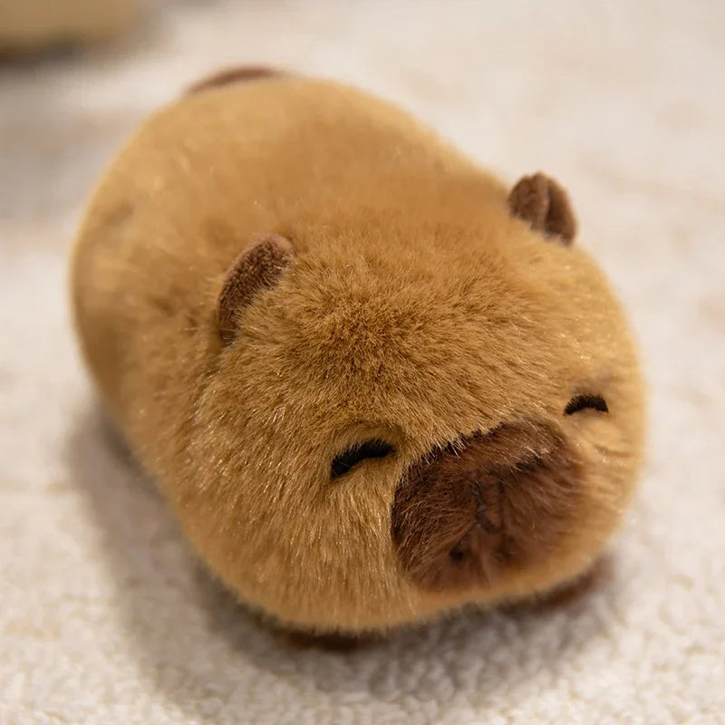 Close-up of a kawaii plush toy resembling a brown animal with closed eyes on a textured surface.