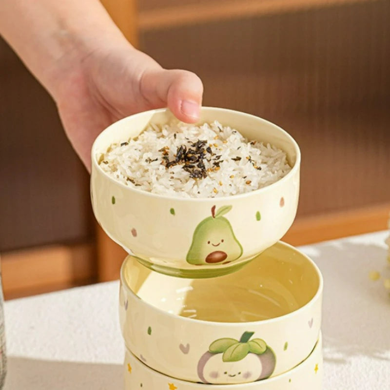 A kawaii bowl with rice inside it being held by someone