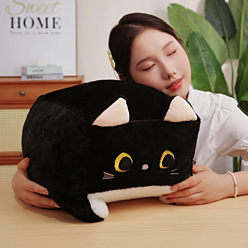 Person holding a black cat-shaped kawaii plush toy in a home setting