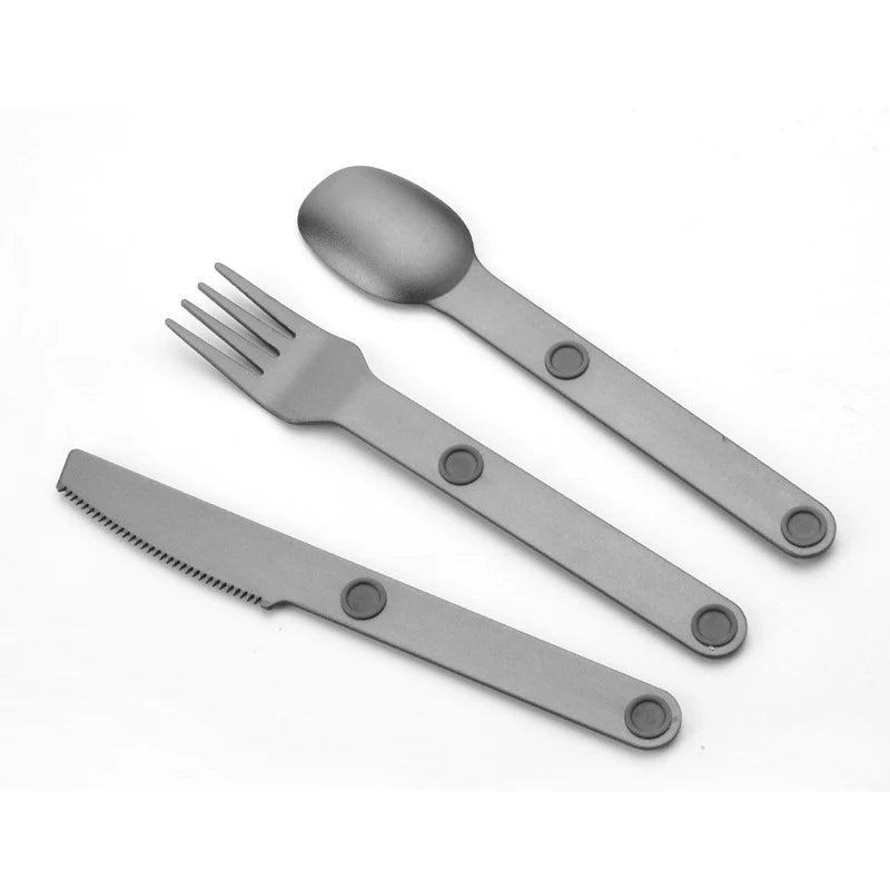 Set of gray kawaii utensils including a knife, fork, and spoon on a white background