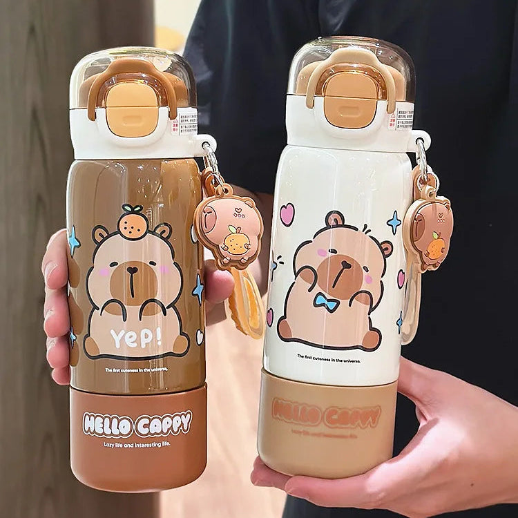 Two cartoon-themed kawaii water bottles held by a person, with a clear background.