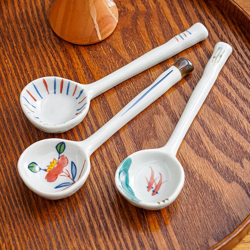 Three white ceramic kawaii spoons on the table