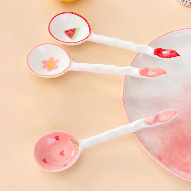 Three white kawaii spoons on a kitchen table