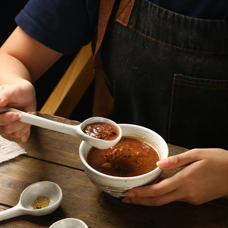 A person holding a kawaii spoon with chilli