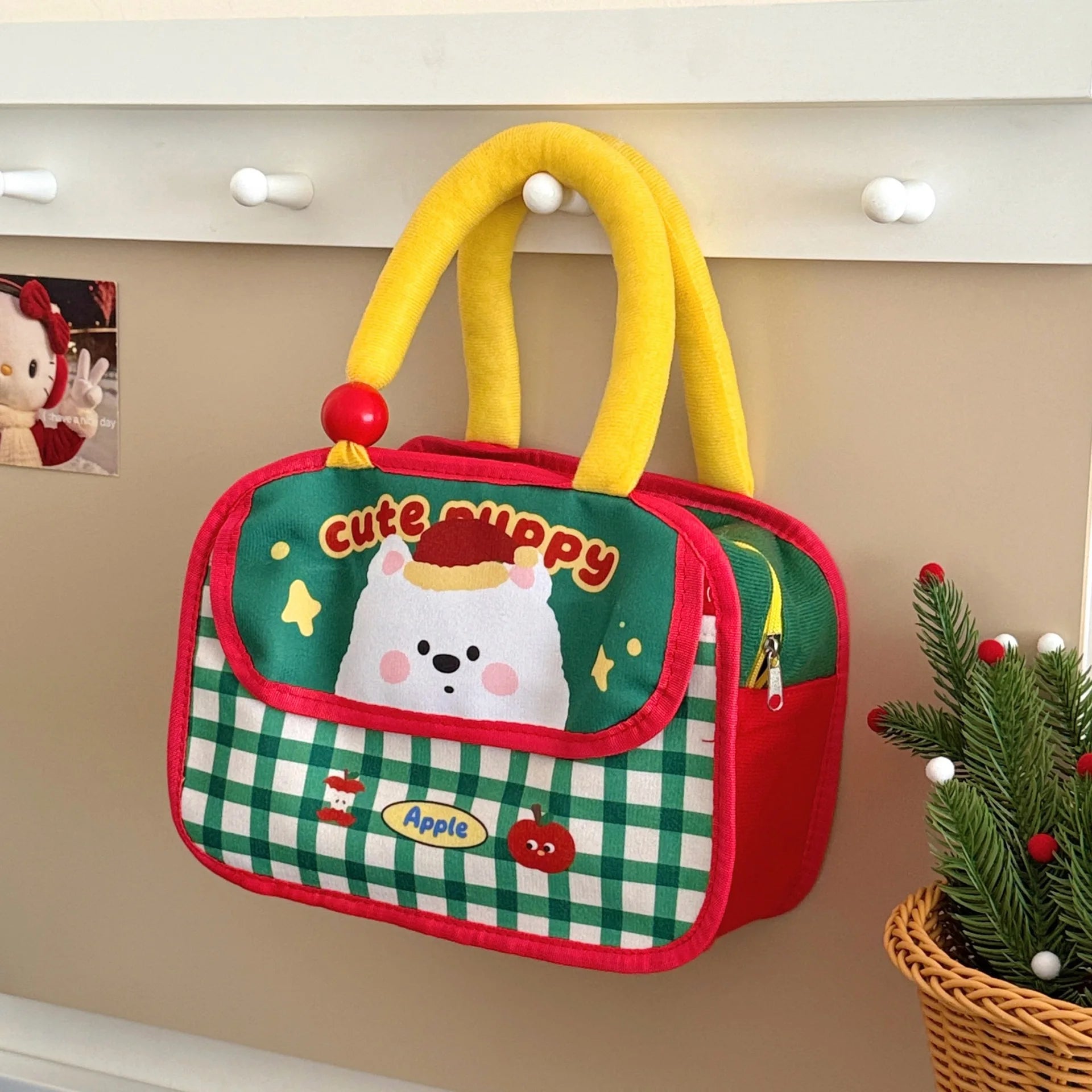 Children's kawaii bag with cartoon design and yellow handle on a beige wall.