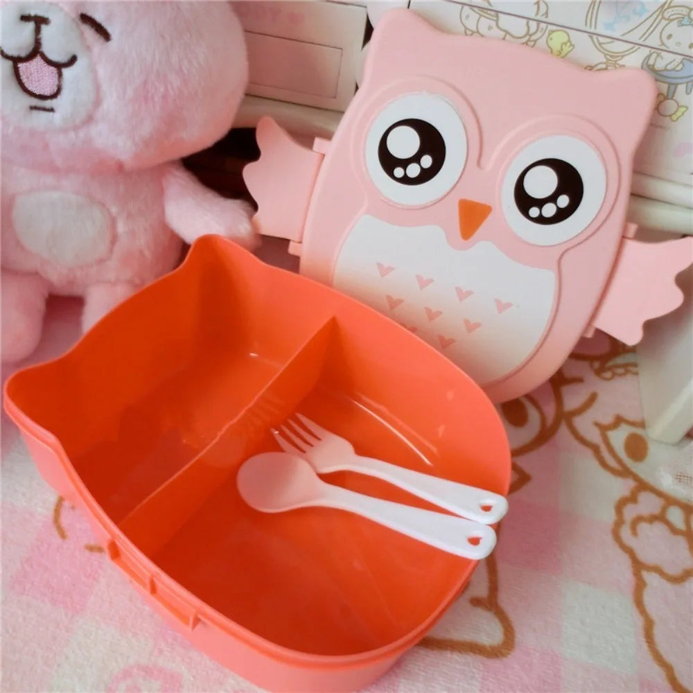 Cute owl-shaped kawaii lunch box with orange container and utensils on a patterned background