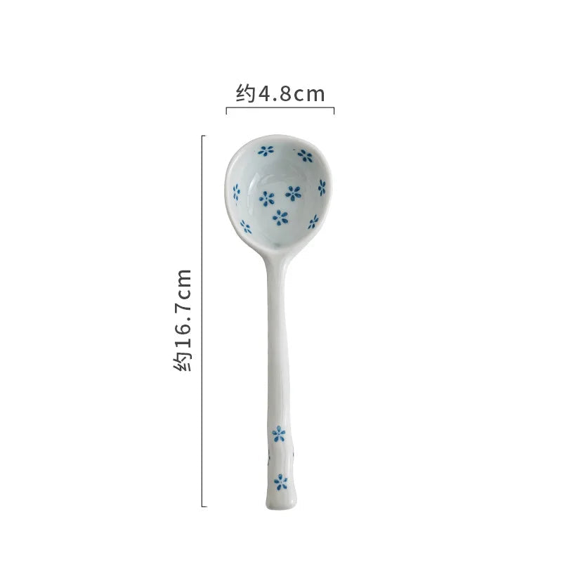 White kawaii spoon with blue floral patterns and measurements on a white background