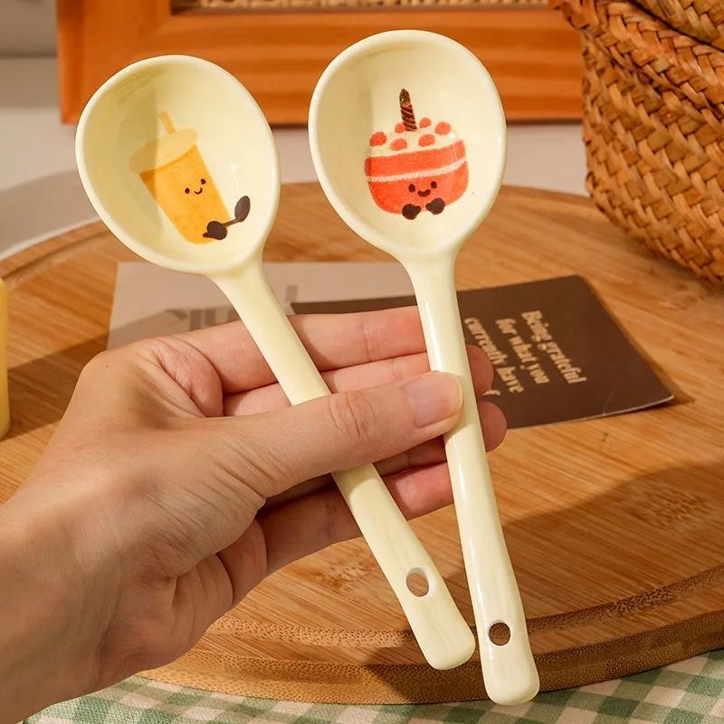 A person holding up two white kawaii spoons