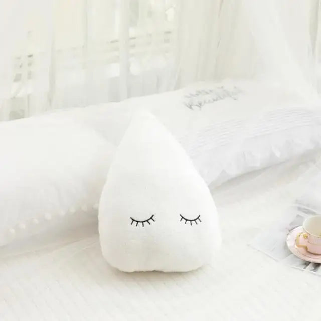 White cloud-shaped kawaii pillow with sleep eye design on a soft white background