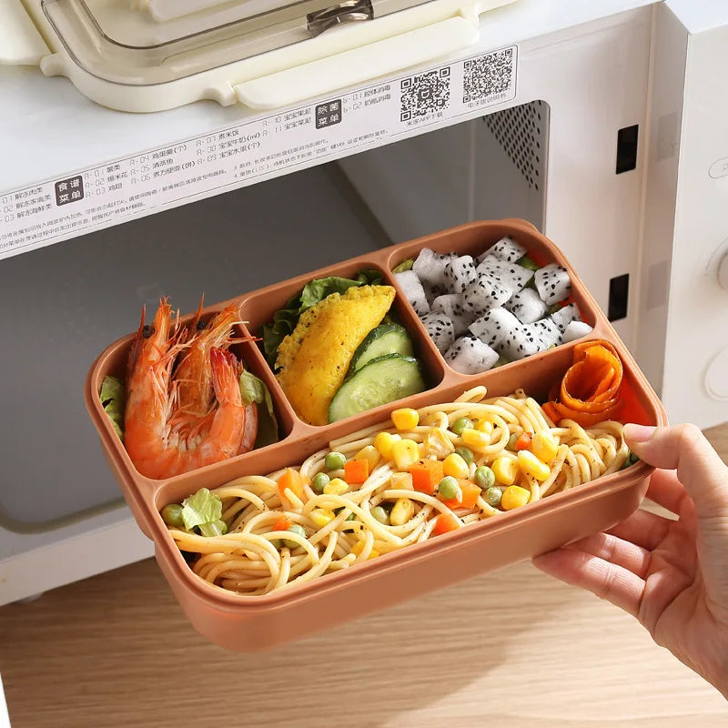Brown kawaii bento box with compartments of food held in front of an open microwave.