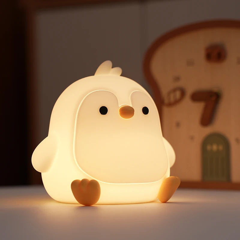 Cute kawaii chick-shaped night light on a blurred background