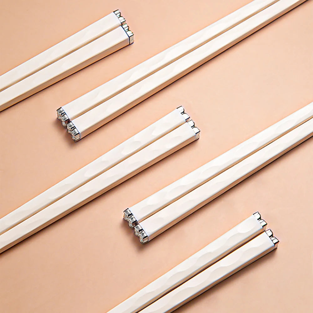 Set of white kawaii chopsticks on a beige background