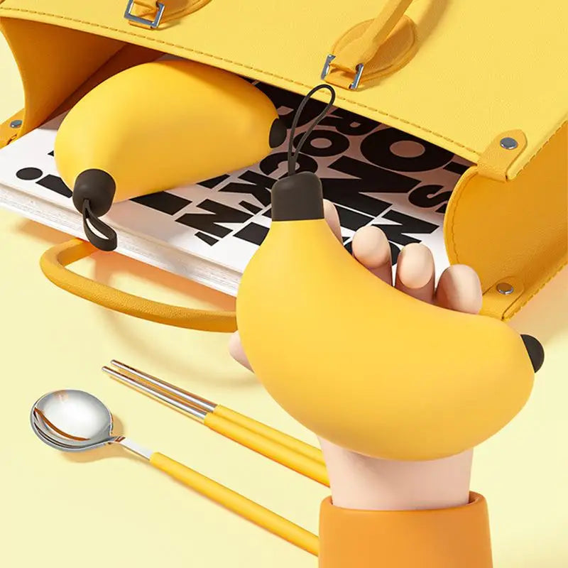 Someone holding a banana shaped kawaii utensils case