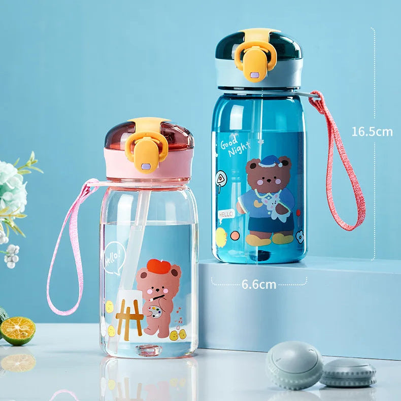 Two children's kawaii water bottles with bear designs on a light blue background