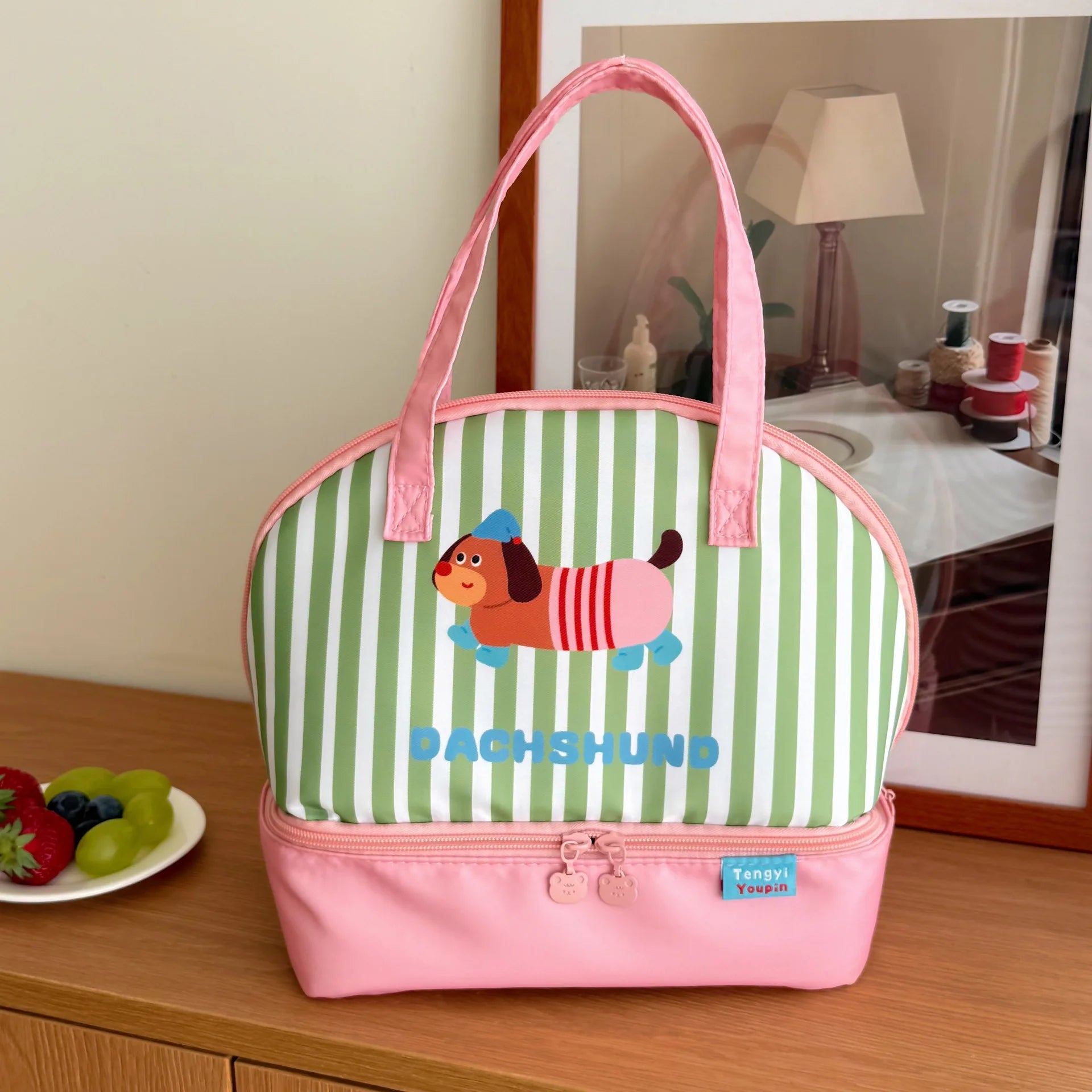 Striped kawaii lunch bag with cartoon dog design on a wooden surface