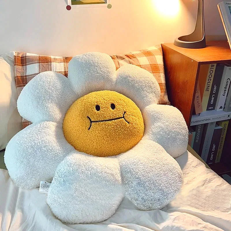 Floral-shaped kawaii cushion with a smiling face on a bed