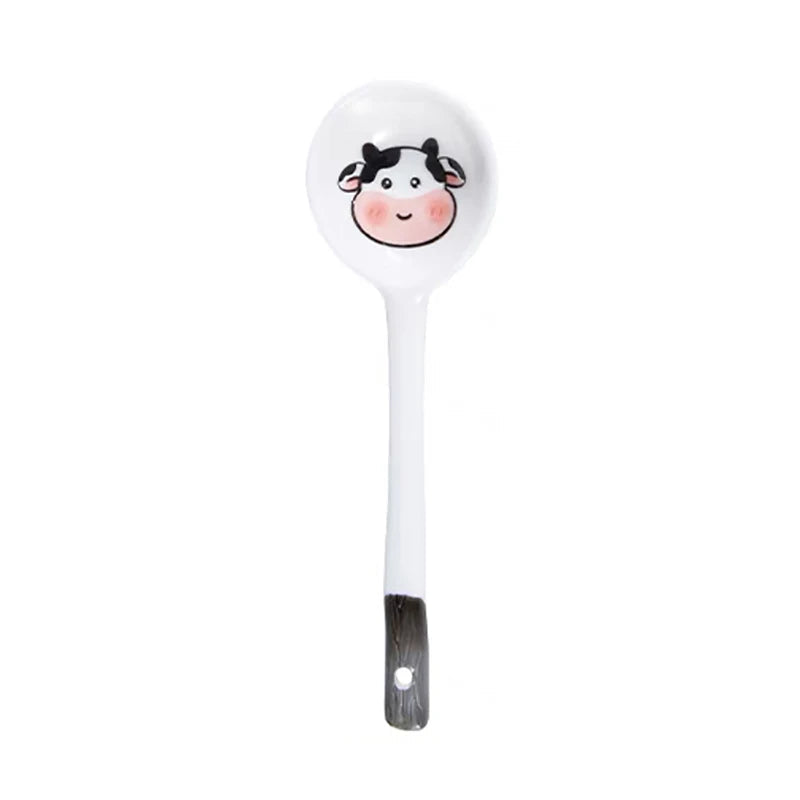 A cow designed white and black kawaii spoon on a white background