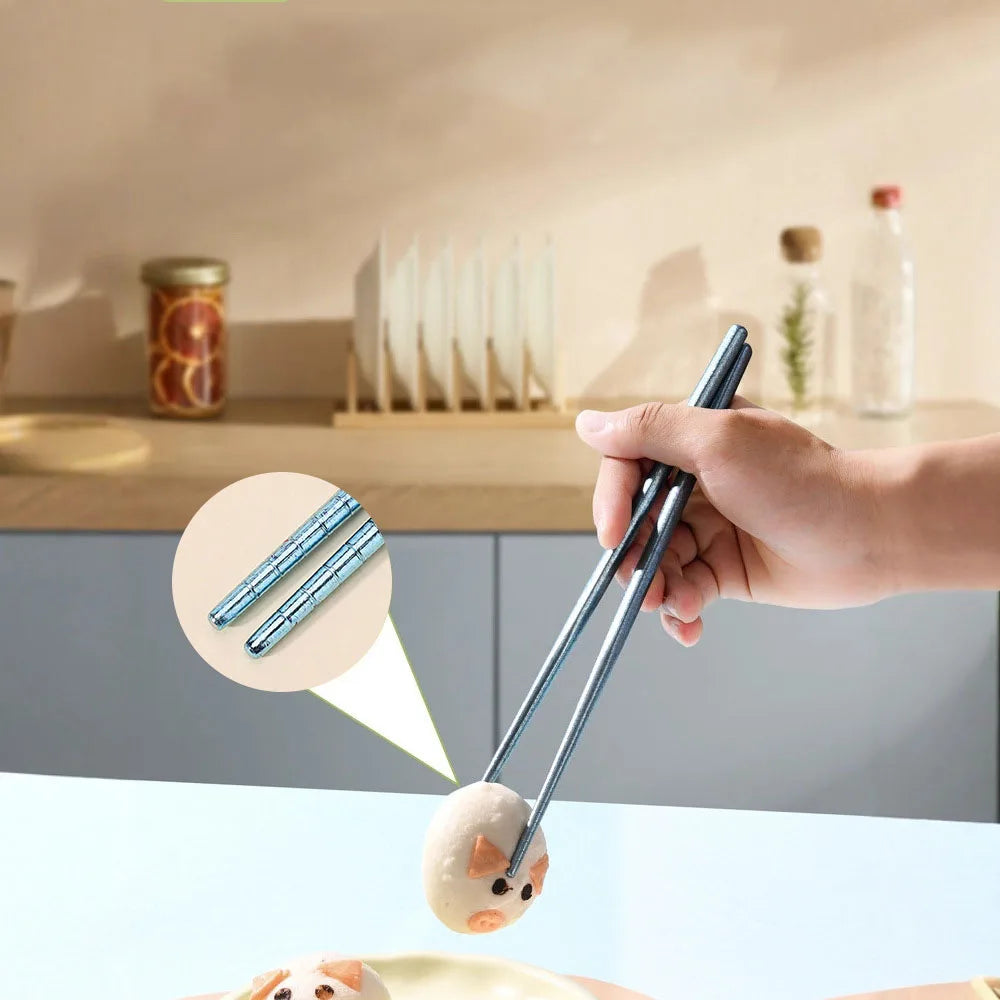 Person using kawaii chopsticks to handle food on a kitchen counter.