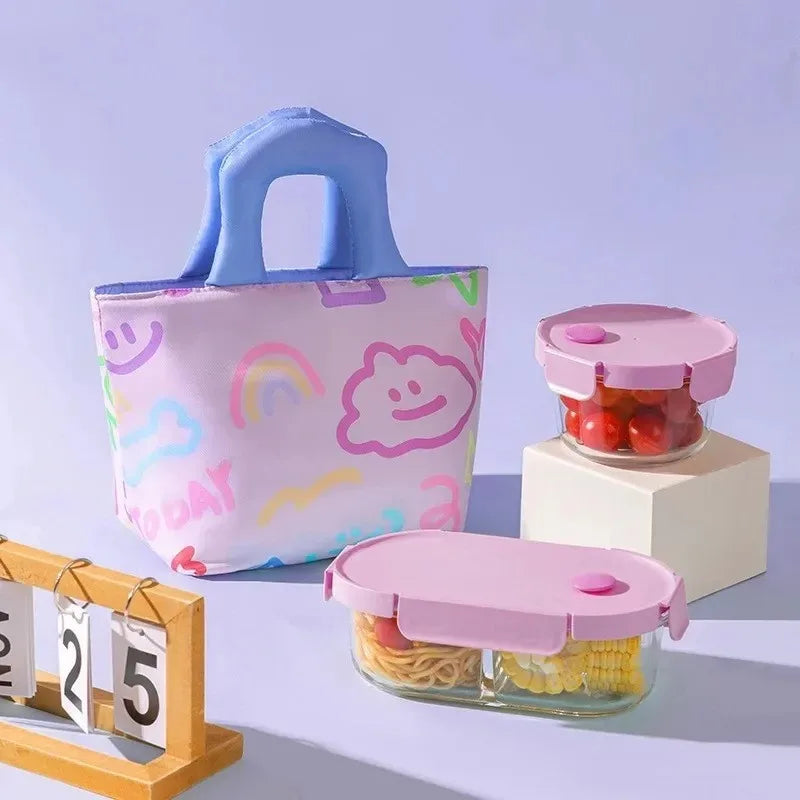 Pink kawaii lunch bag with lids and a tote bag with cloud and rainbow patterns on a light blue background.